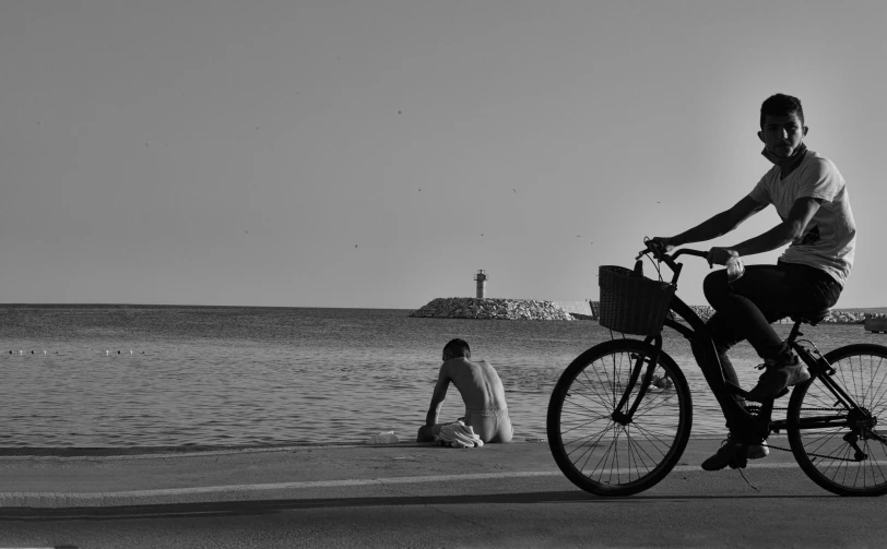 a man is riding his bicycle on the side of the road