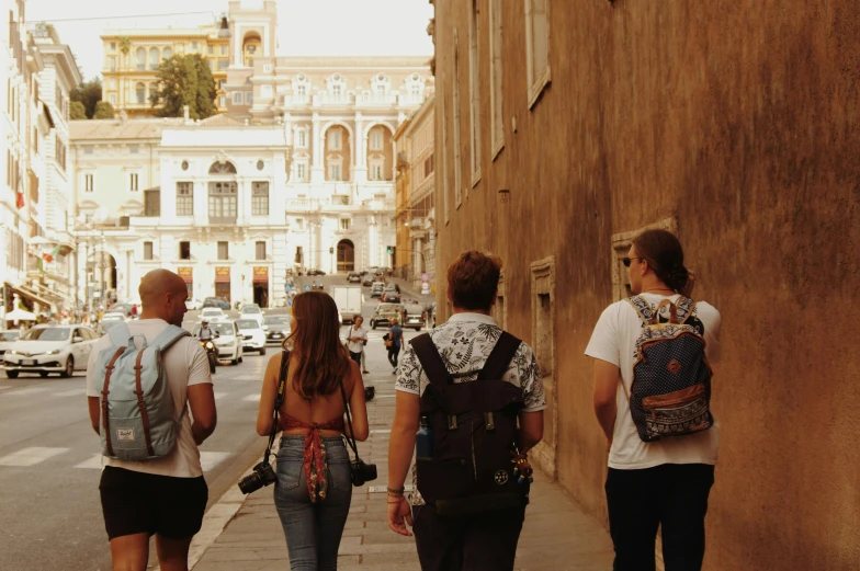 three teenage boys are walking in the street