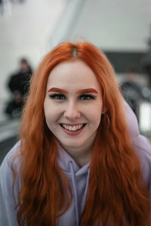 an attractive redheaded woman smiling at the camera