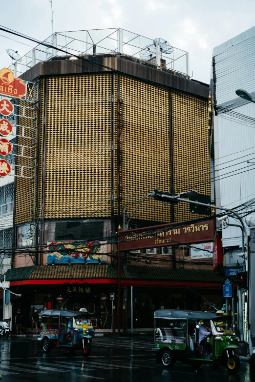 an oriental building on a wet city street