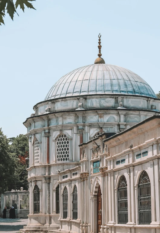 a large ornate white building with a blue top