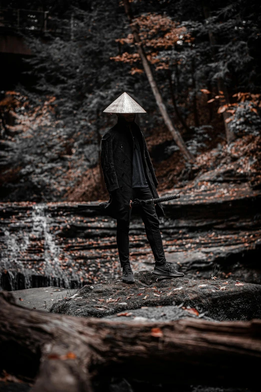 a man walking in the woods in a straw hat