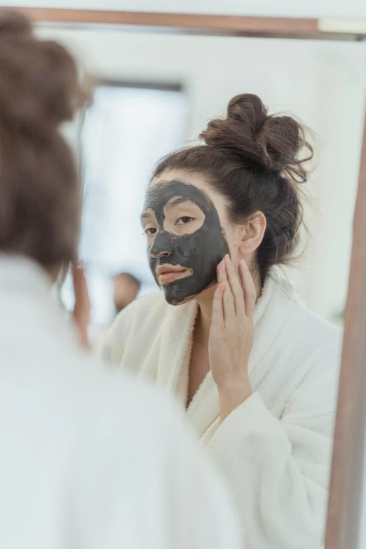 a woman is reflected in the mirror with a mask on