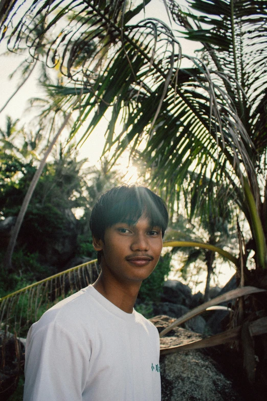 a boy is posing for the camera on the beach