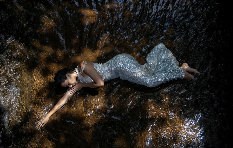 an aerial po of a woman floating in the water