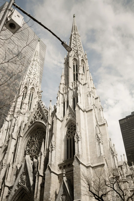 a gothic structure that is under a cloudy sky