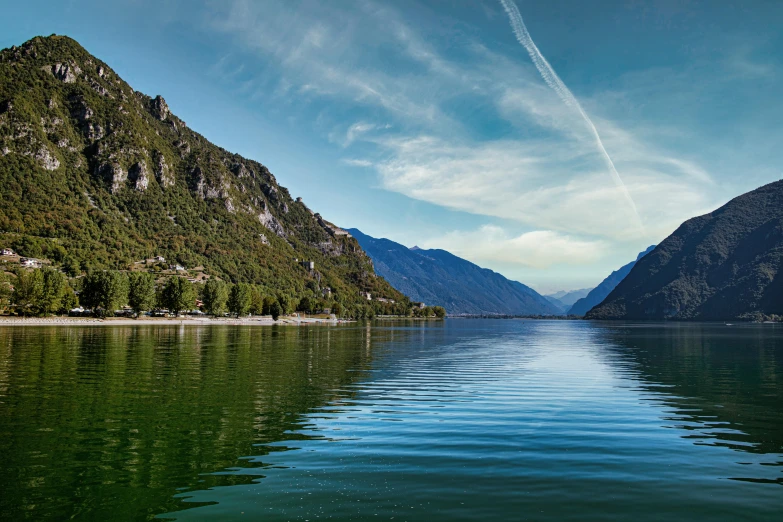 the clear water and mountains are visible from across the lake