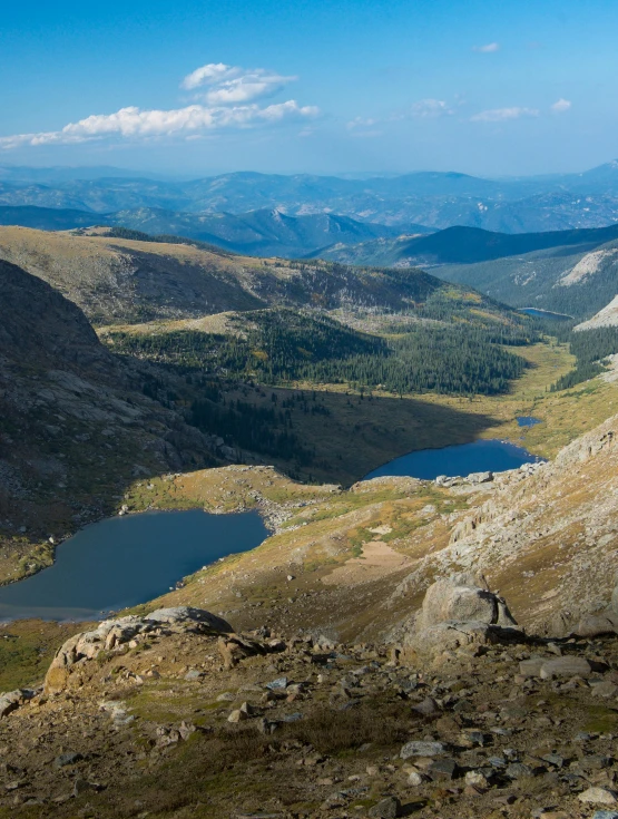 the view from the top of a mountain shows a lake