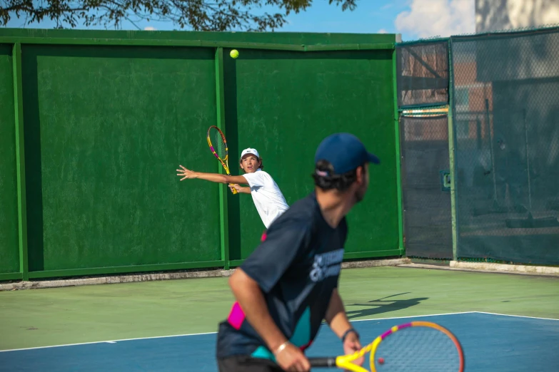 a young man hitting a tennis ball back on a court