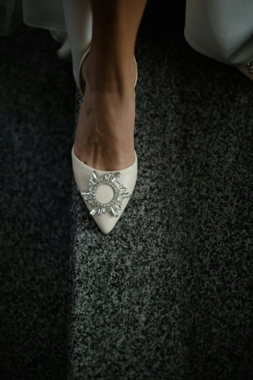 closeup of a womens feet in white high heel shoes