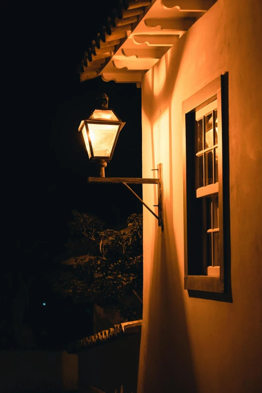 a street lamp by a window at night