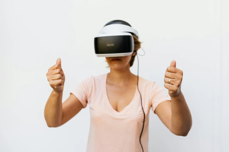 woman with headphones giving a thumbs up sign