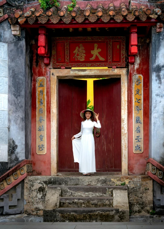 a woman posing for a po in front of a temple