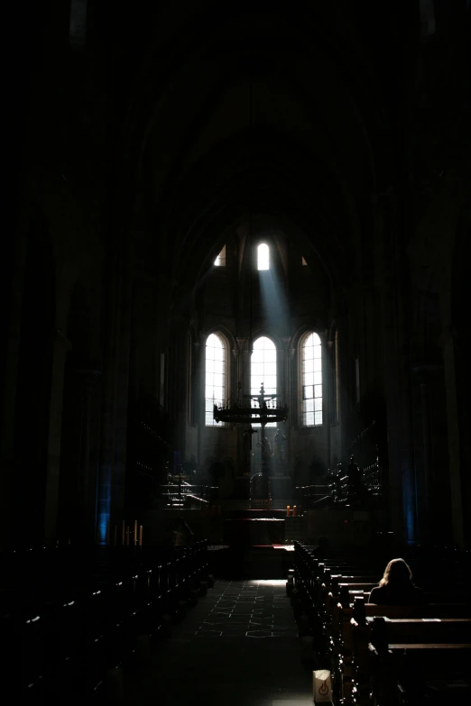 a church with stained glass windows and benches in front