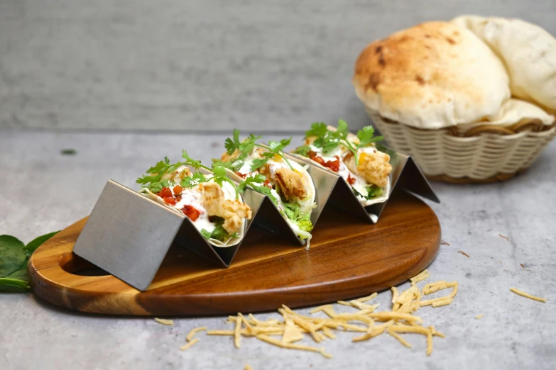 five wraps with food in them sitting on a  board