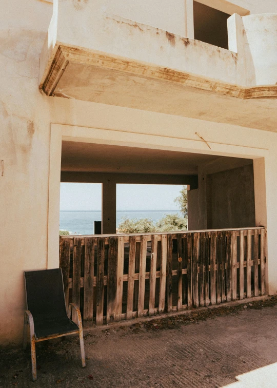 the window of an abandoned building overlooking a body of water