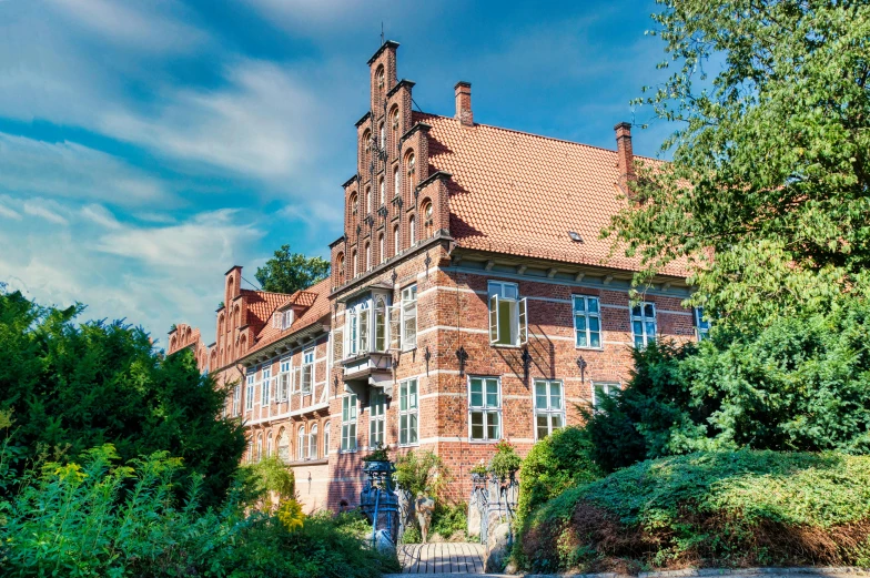 an old red brick building in front of trees