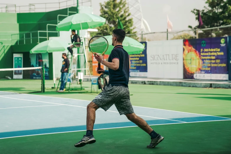 a tennis player is running and holding his racket