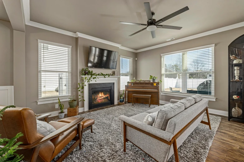 a nice living room with large windows, couches and television