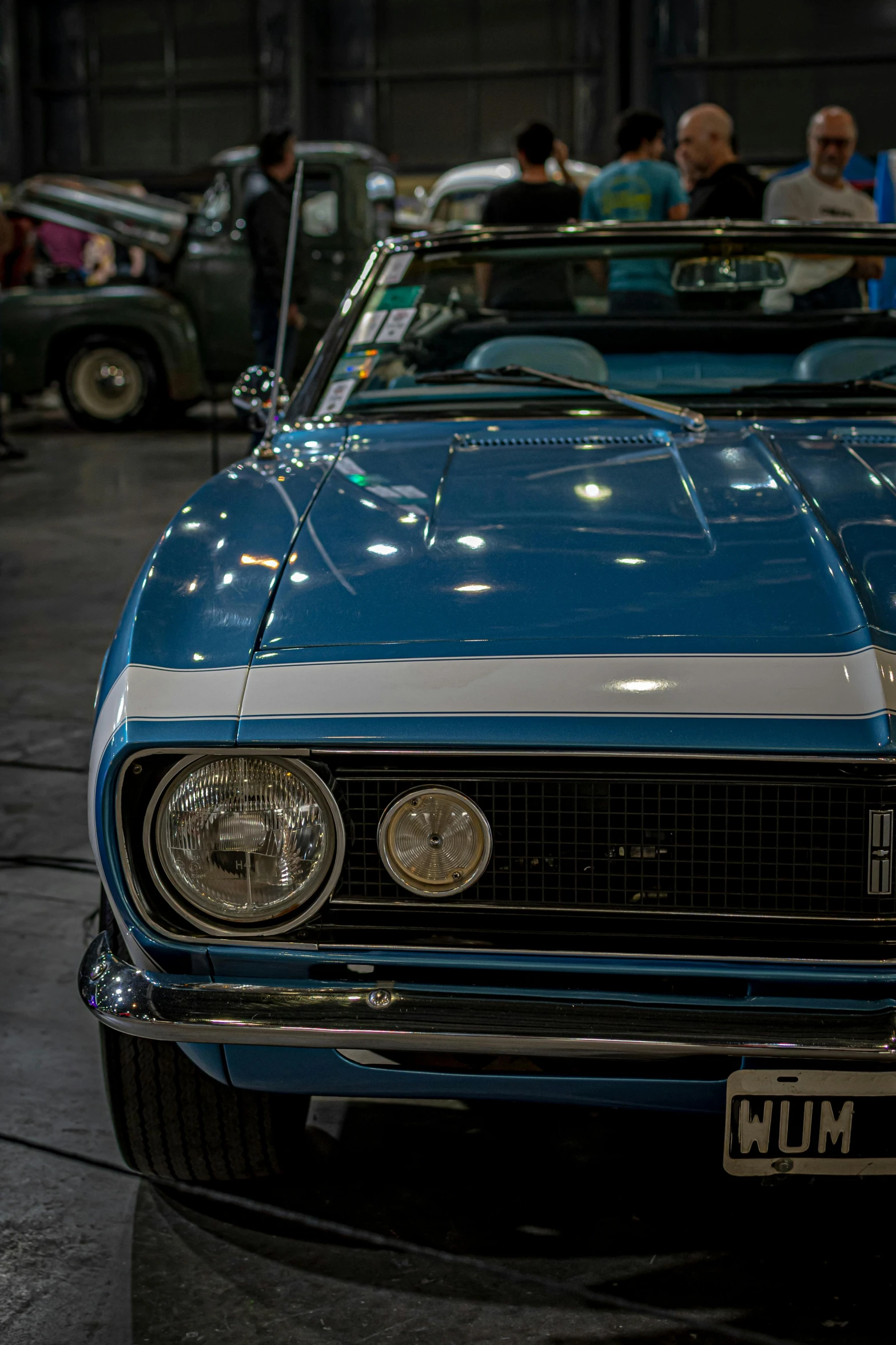 an old blue mustang mustang parked in a garage