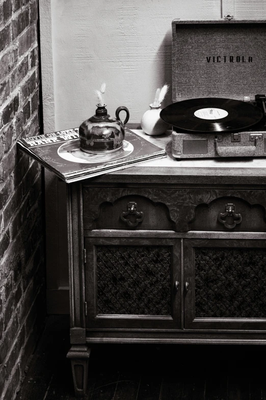 a record player is sitting on a dresser