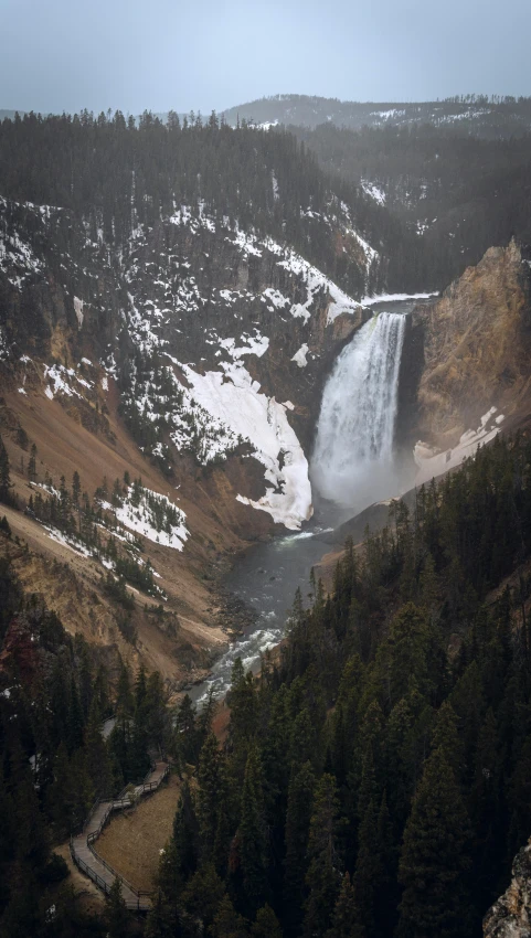 the view from the top of the falls looking down on a frozen waterfall