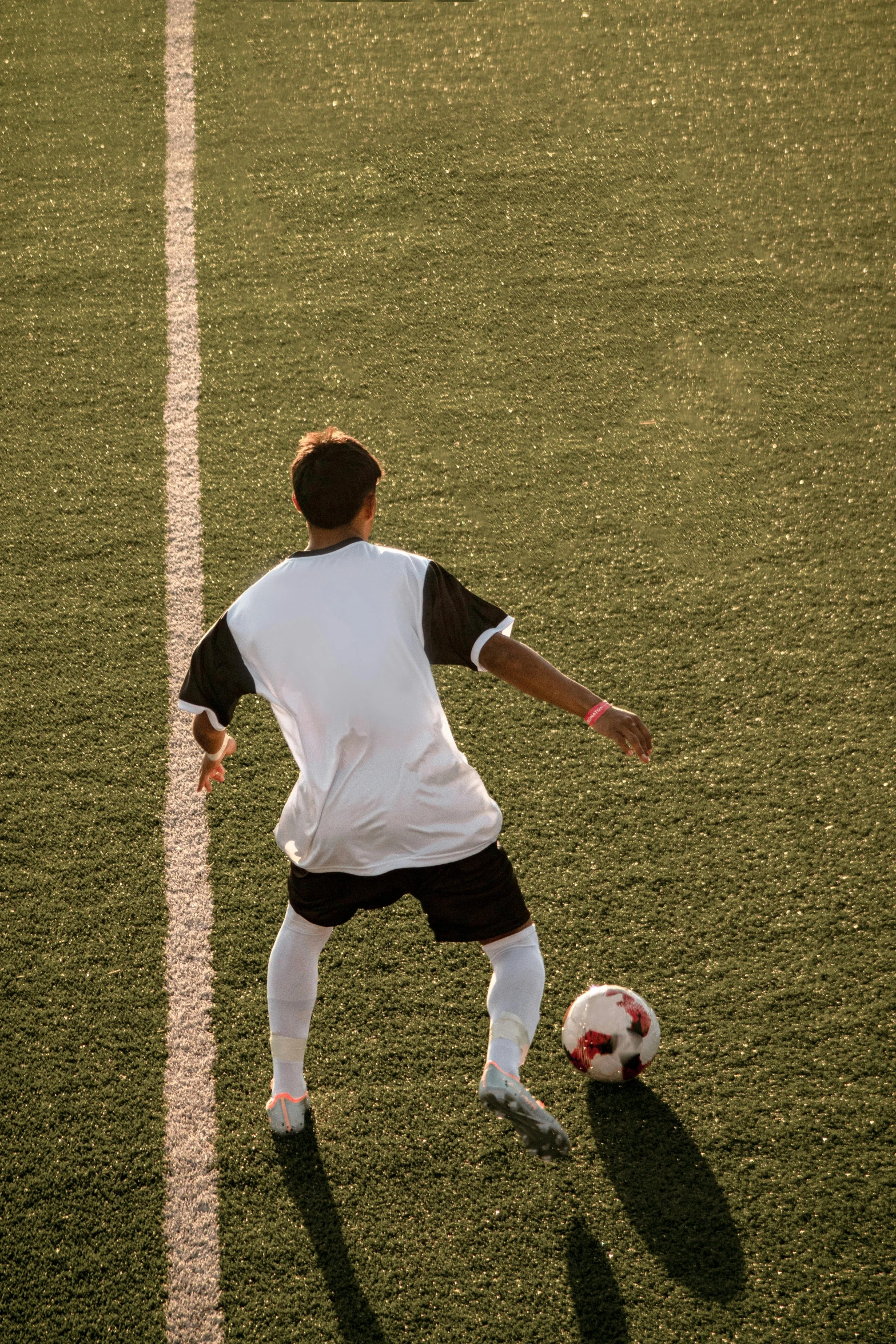 a man on a field playing with a soccer ball