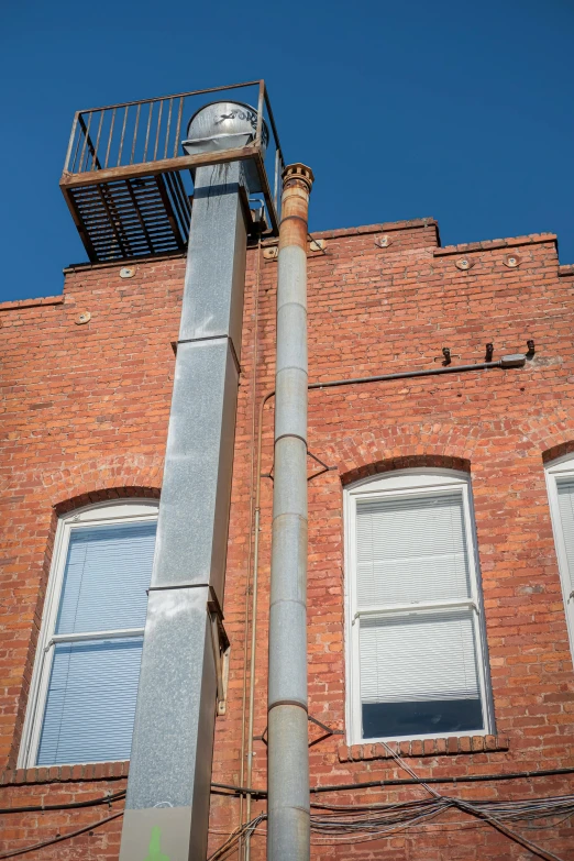 the top portion of a tall brick building under blue skies