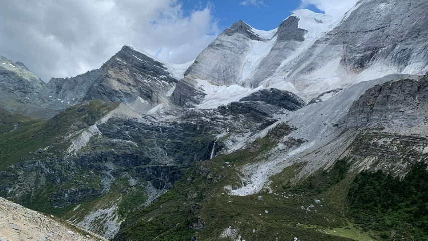 a man standing on top of a rock near a valley