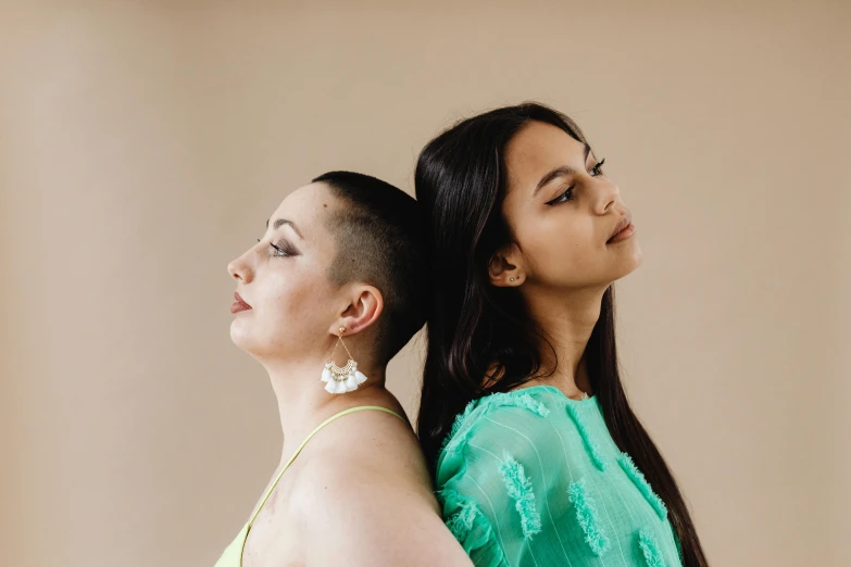 two women with long hair staring at soing