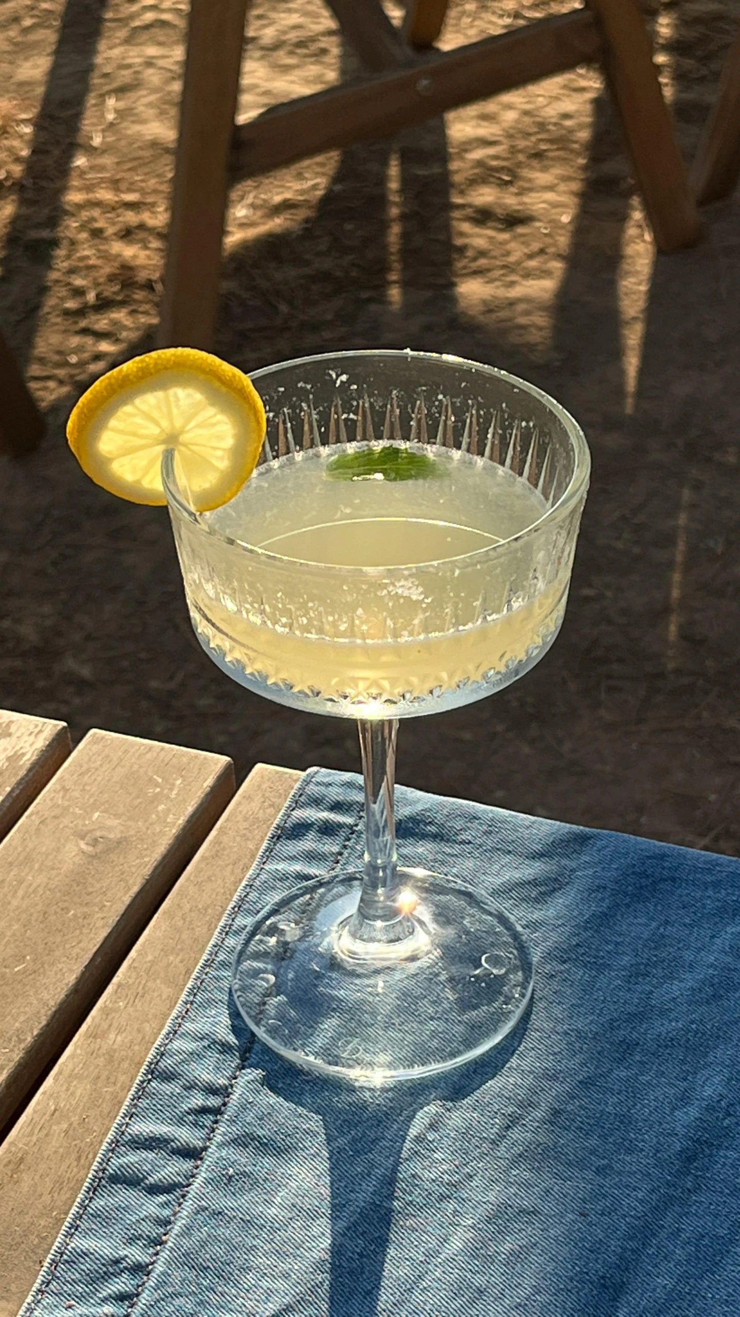 a very tasty looking martini is on a blue cloth