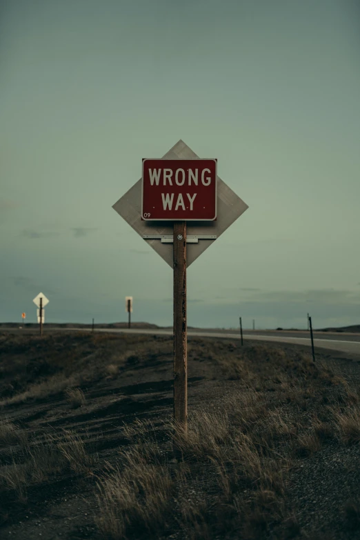 a sign is standing in the middle of a field