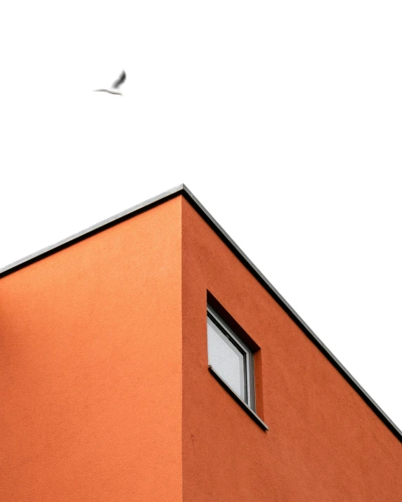 an orange wall with a single small window