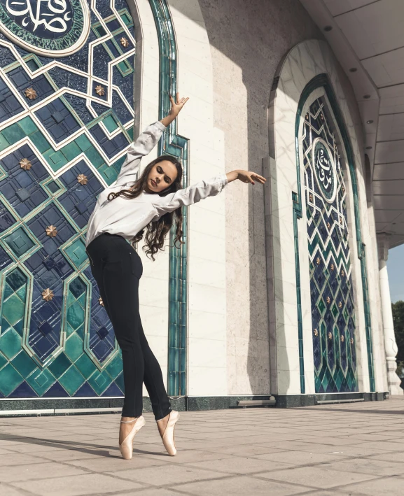 a woman is doing yoga outside of a colorful wall