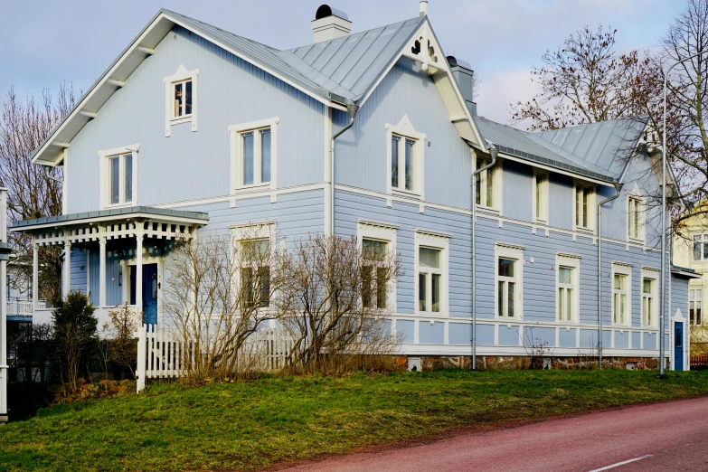 two large blue buildings with windows on the side of them