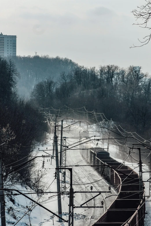 train tracks on the side of a snowy track