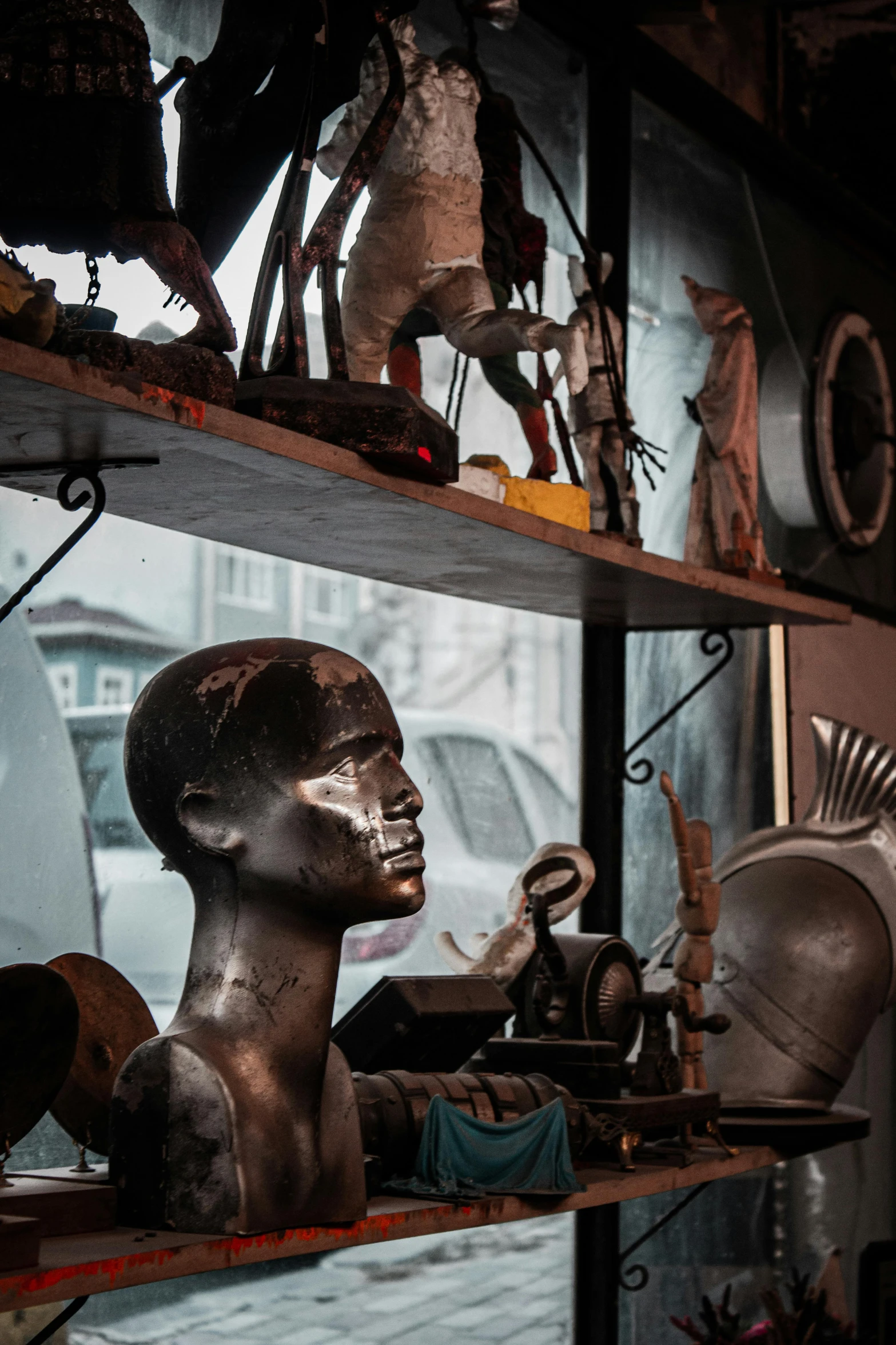 various sculptures displayed behind glass on shelves