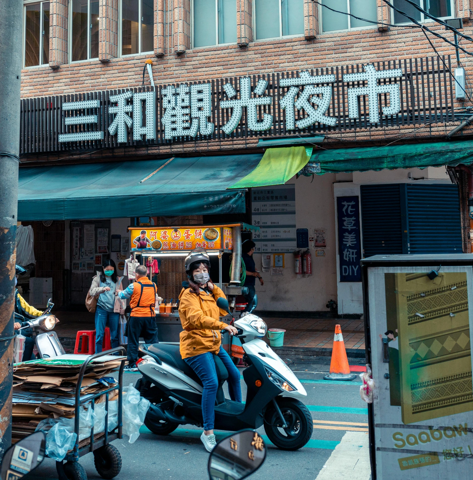 a person riding a scooter on a city street