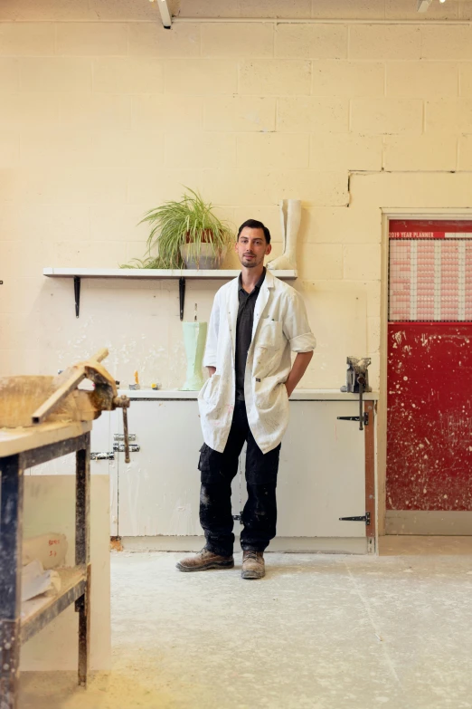 a man that is standing in a room with some shelves