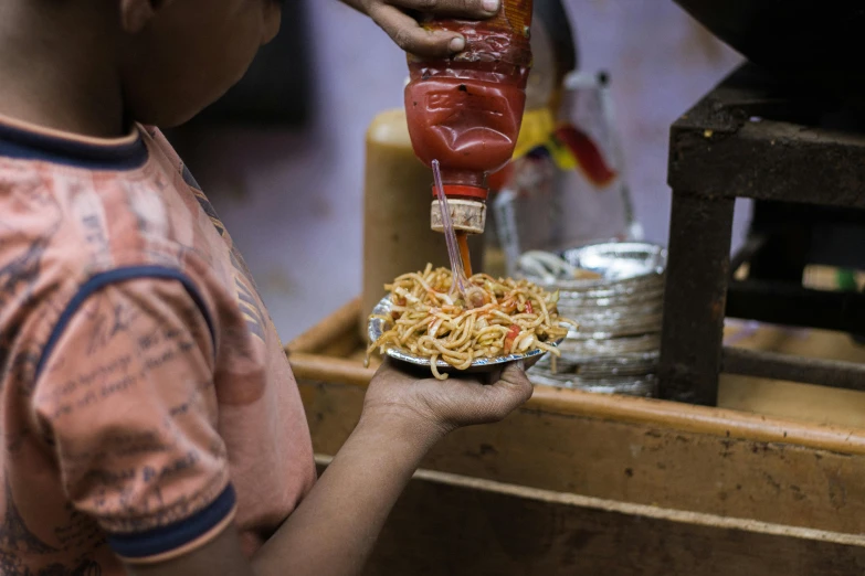 a man is making a bowl with noodles