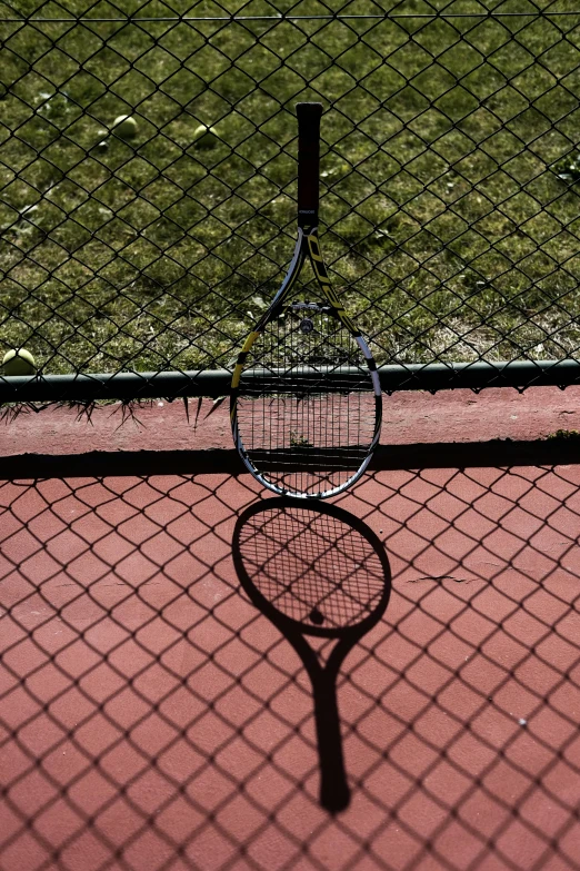 shadow from the tennis racket on a court