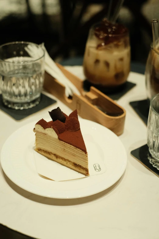 a slice of cake is sitting on a plate near another slice of cake