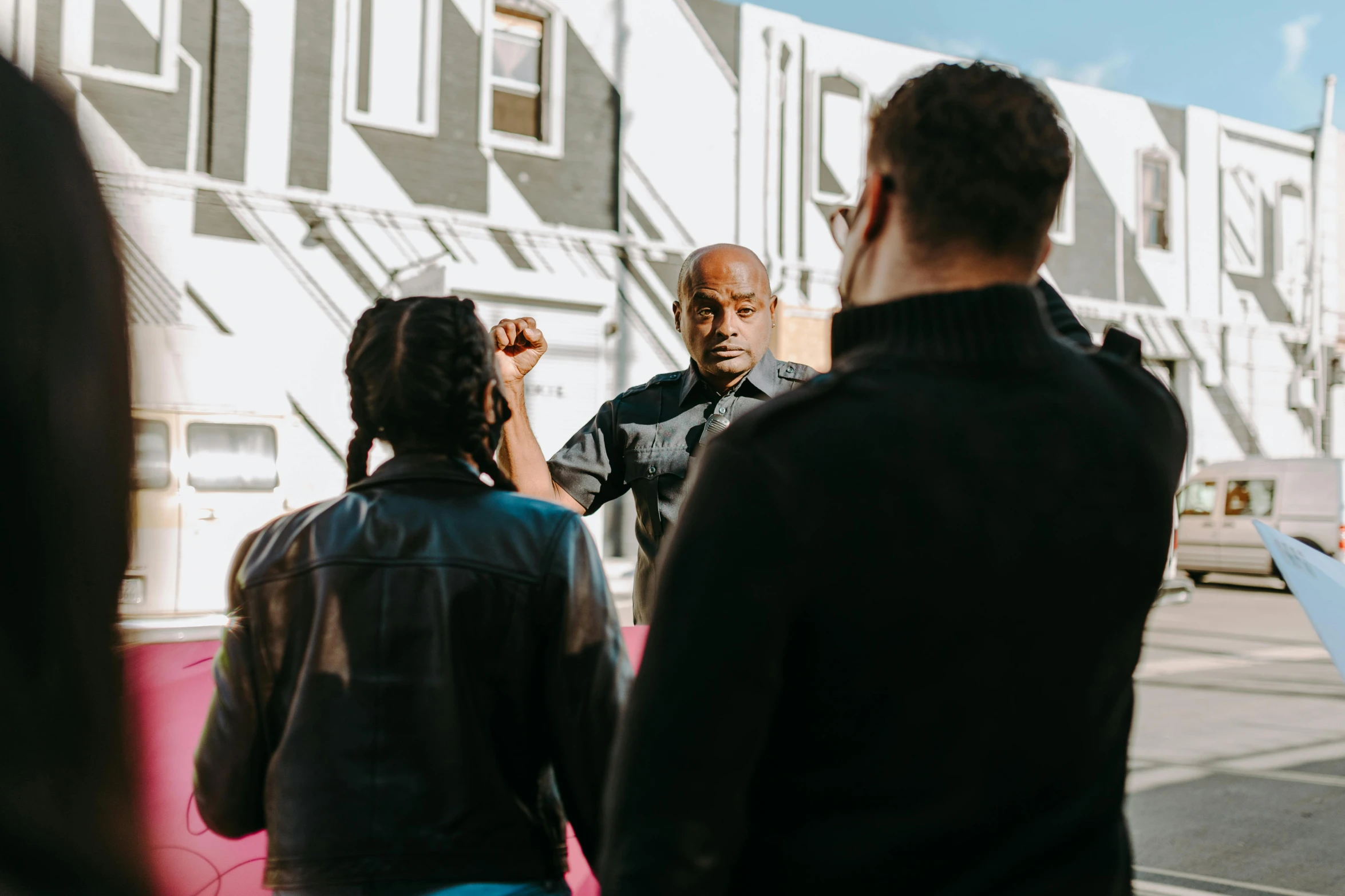 the men and women are standing together outside of a building