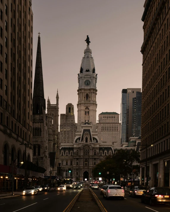 a road with cars driving down it and an old building in the background