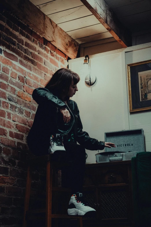 an old lady in a bar pointing to an old radio