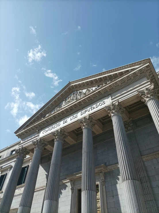 a building with four stone pillars standing in front of the sky