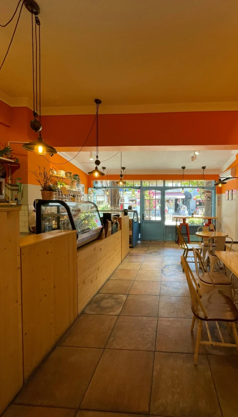 tables in a cafe area with benches and chairs