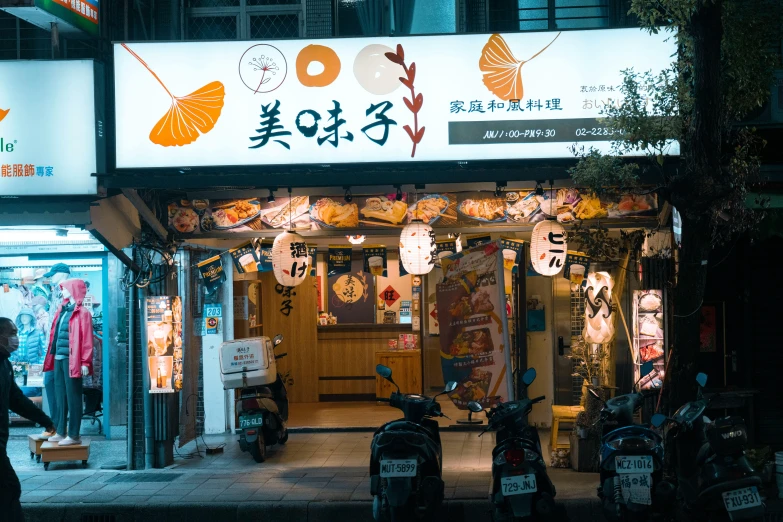 people are standing in front of a store at night