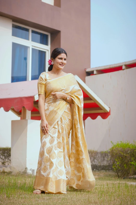 a woman wearing an elaborate golden sari