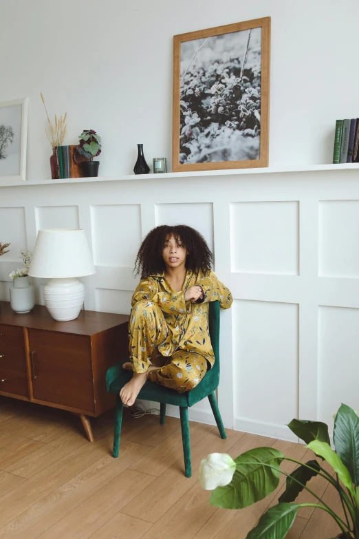 a woman is sitting on a chair and smiling